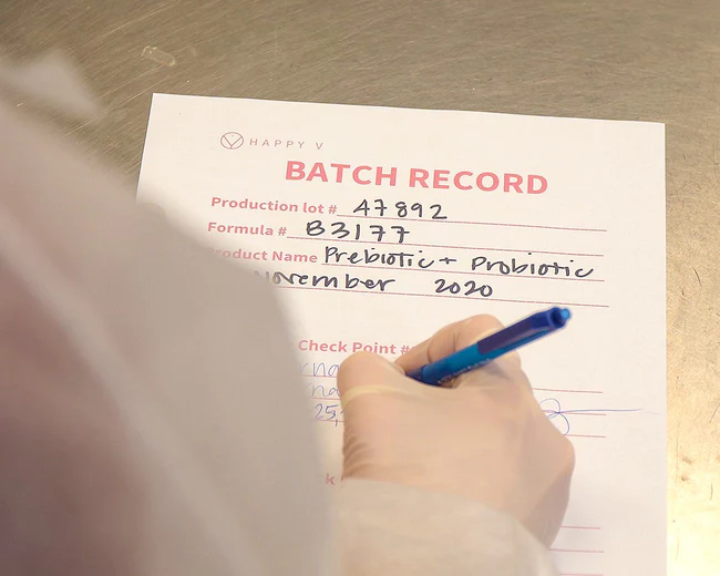 Batch record form with handwritten details for Happy V prebiotic and probiotic.